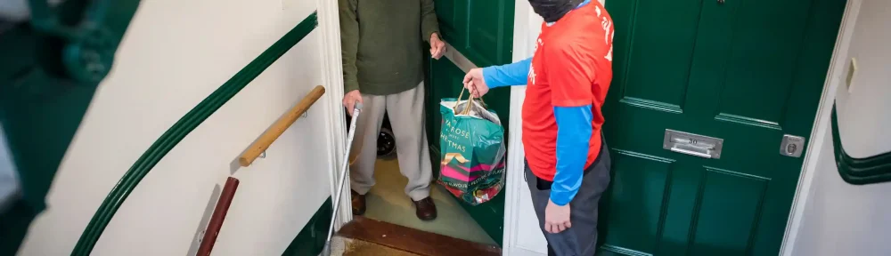 GoodGym volunteer delivering shopping to a house-bound older person