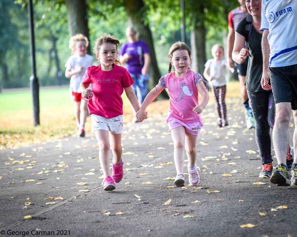 Two girls holding hands and running 